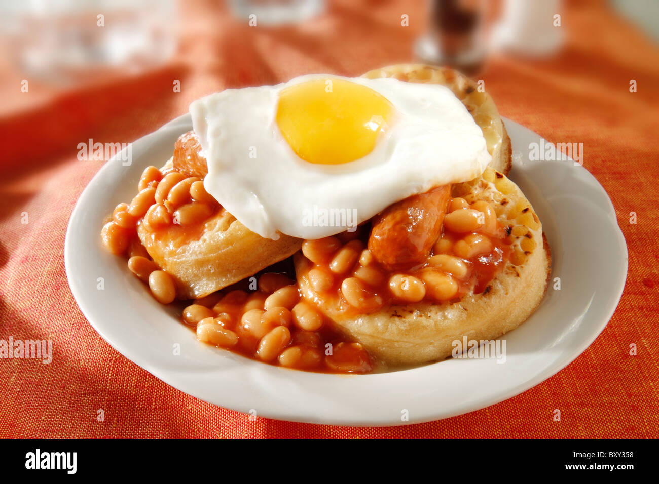 Baked beans and fried egg on buttered crumpets Stock Photo Alamy