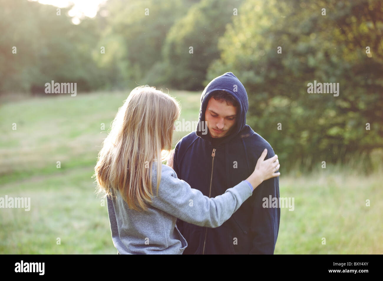 A young couple outdoors, man looking sad Stock Photo