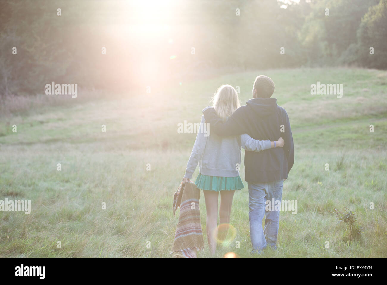 Rear view of a young couple walking in the countryside Stock Photo