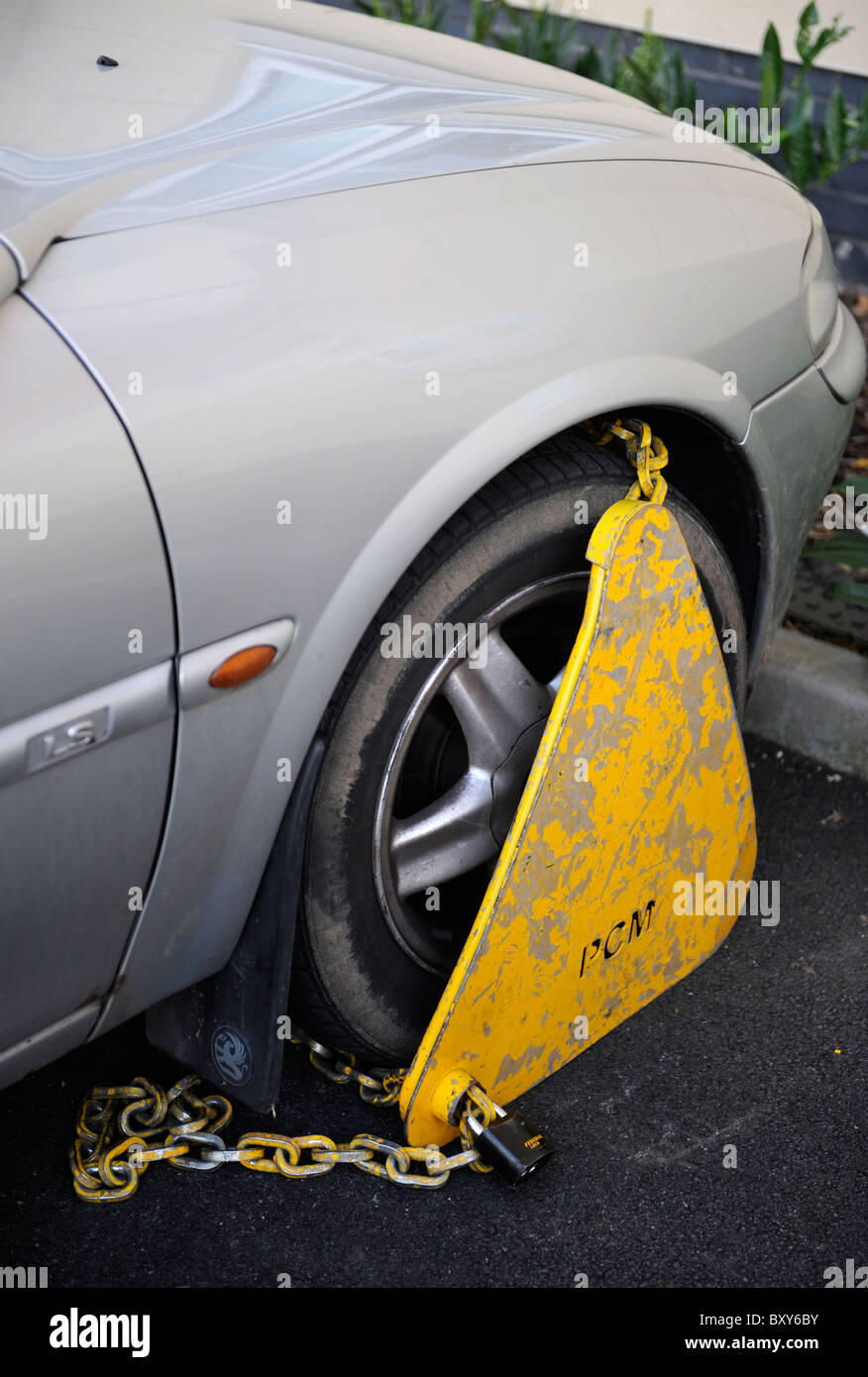 A clamped car parked in a residential area UK Stock Photo