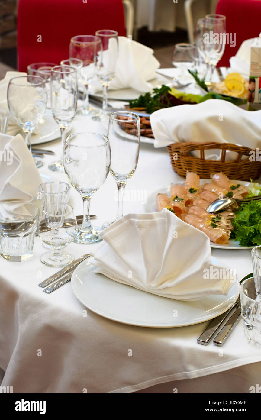 Elegant banquet and dinner tables prepared for a holiday or a party. Wedding white reception place ready for guests. Stock Photo