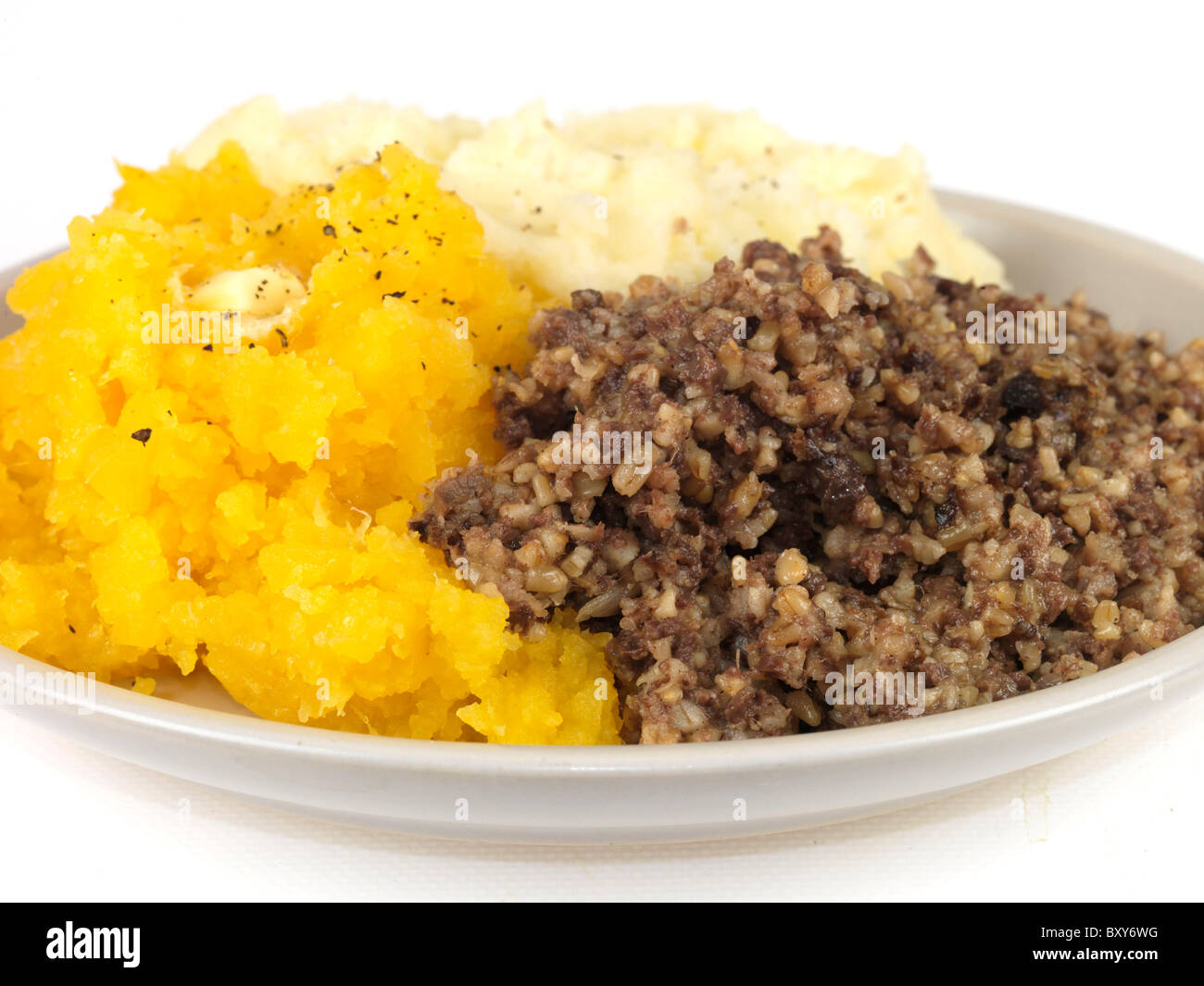 Authentic Style Scottish Burns Night Haggis With Swede And Mashed Potatoes Against A White Background With No People And A Clipping Path Stock Photo