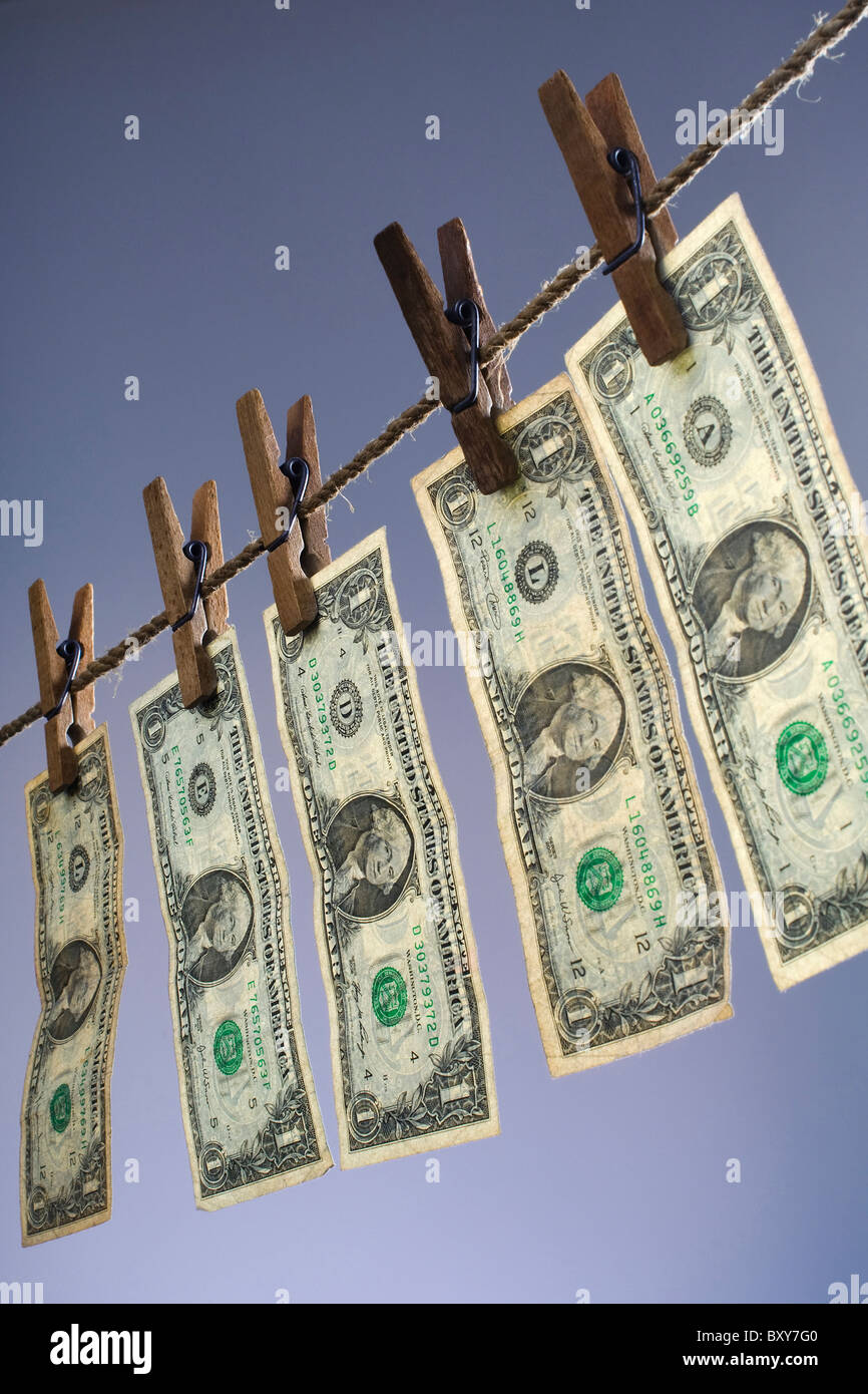 five one dollar bills hanging on a clothesline Stock Photo