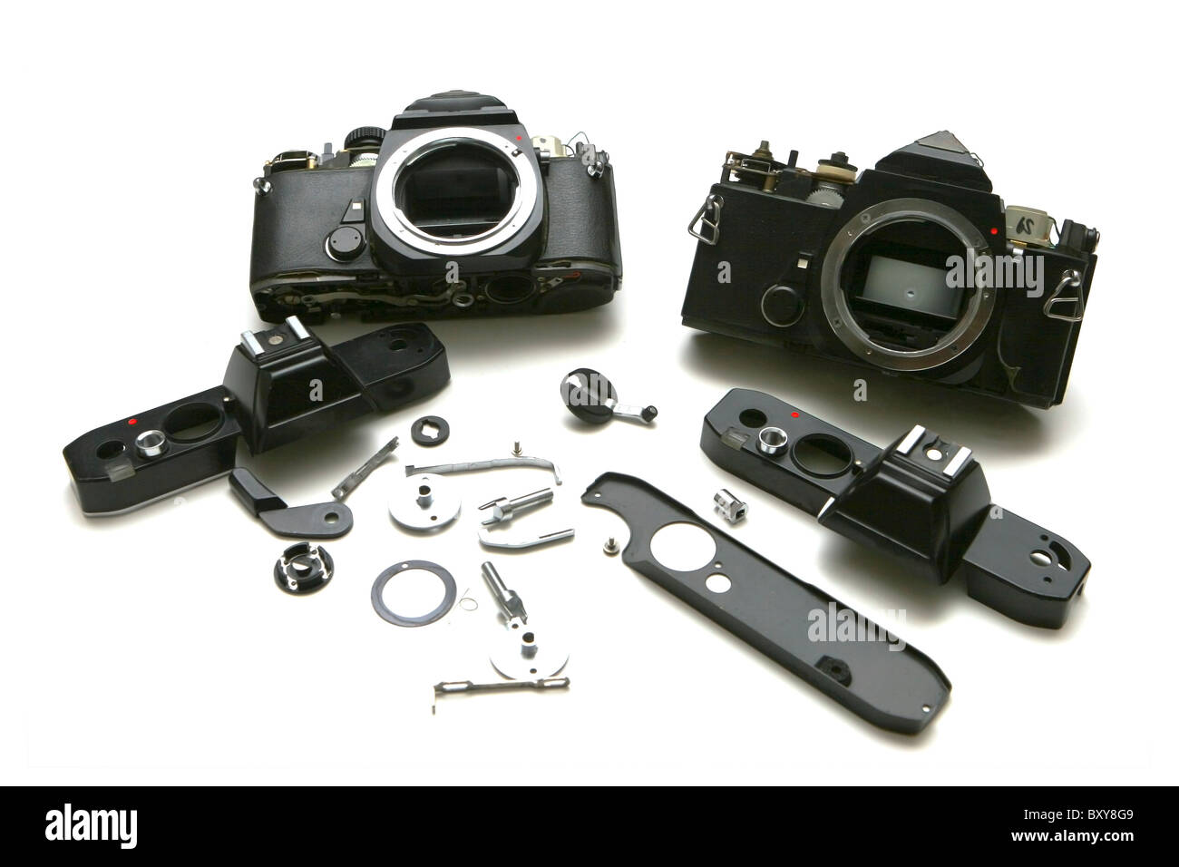 2 film SLR Cameras, disassembled for repair. On White. Branding removed