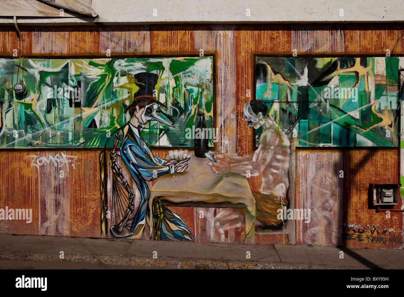 Wall mural depicting two men playing cards along a street in the Spanish colonial city of Santiago de Queretaro, Queretaro, MX Stock Photo