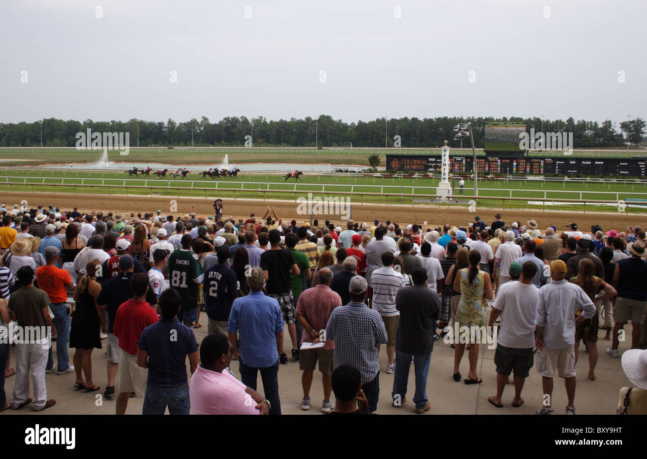 Crowd cheering as horses approach finish line at Colonial Downs racetrack. New Kent County, Virginia 2010 Stock Photo