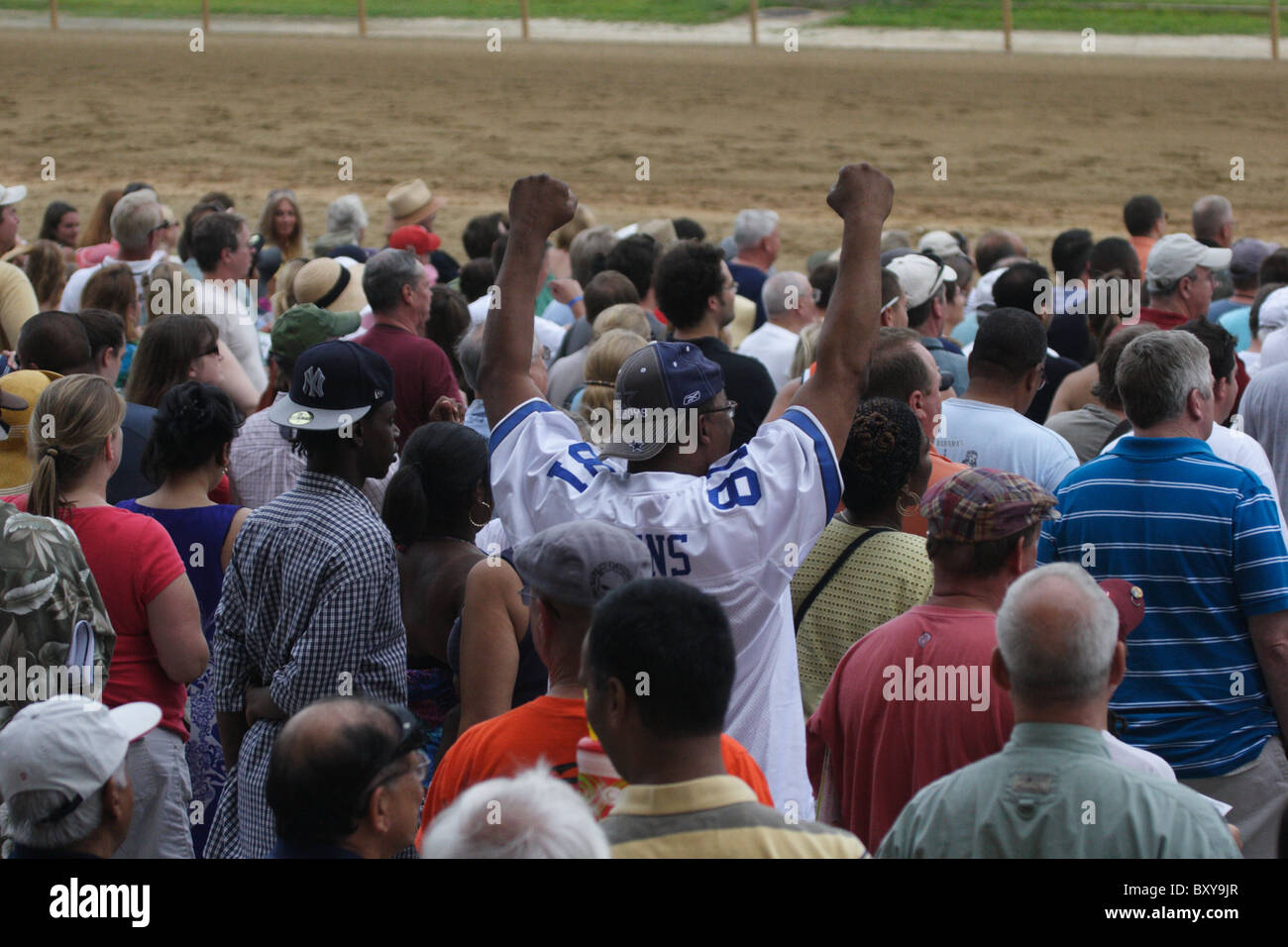 Crowd cheering as horses approach finish line at Colonial Downs racetrack. New Kent County, Virginia 2010 Stock Photo