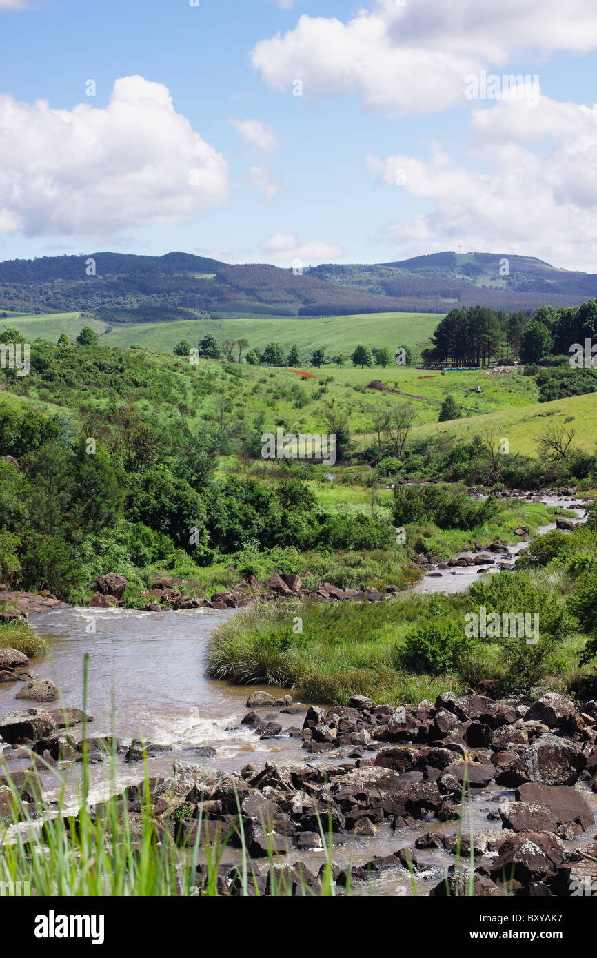 A rocky stream winding through farmlands in the Balgowan region of the Midlands, KwaZulu Natal, South Africa. Stock Photo