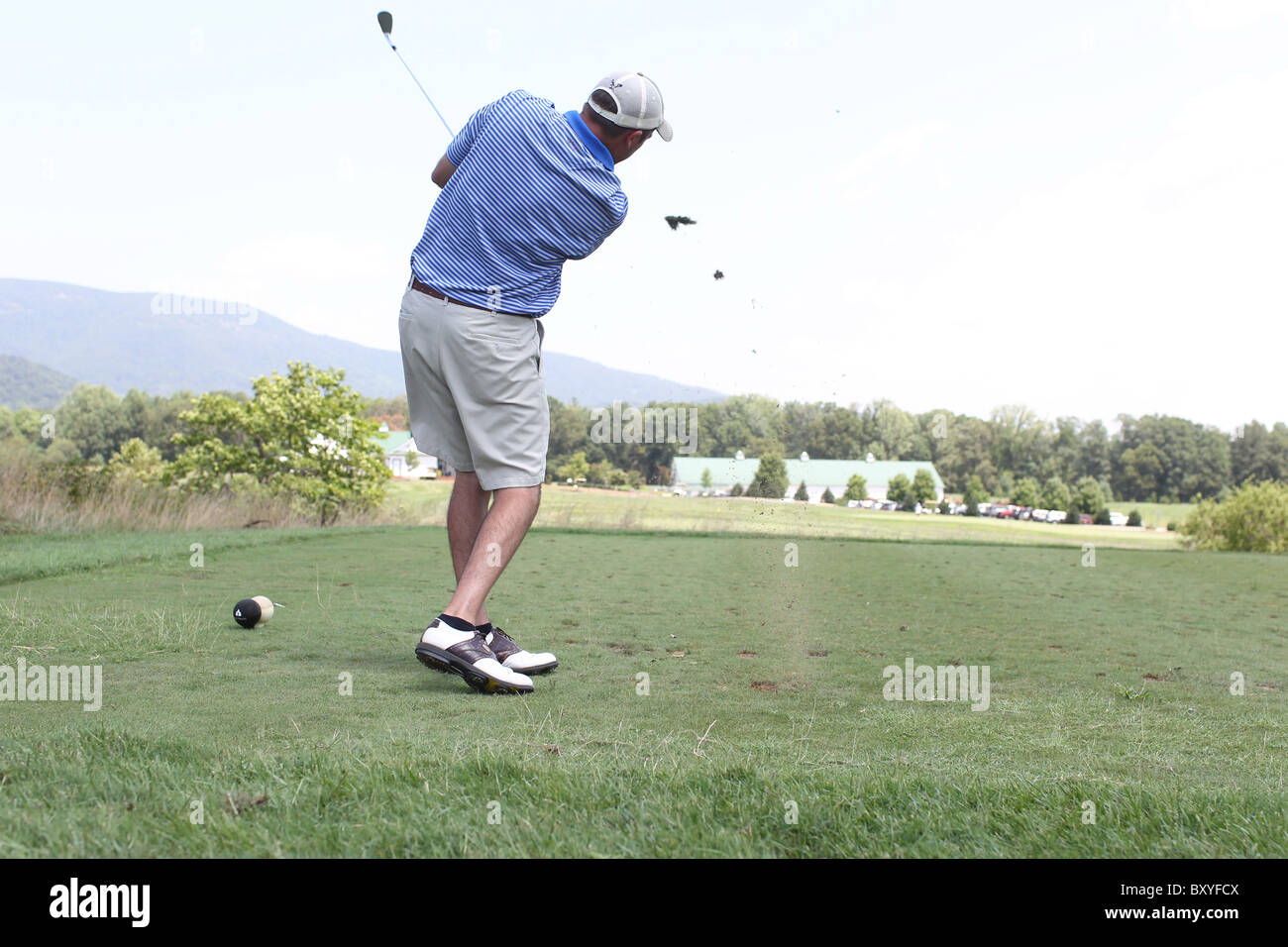 Golfer tees off at a local golf course in Charlottesville, VA. Stock Photo