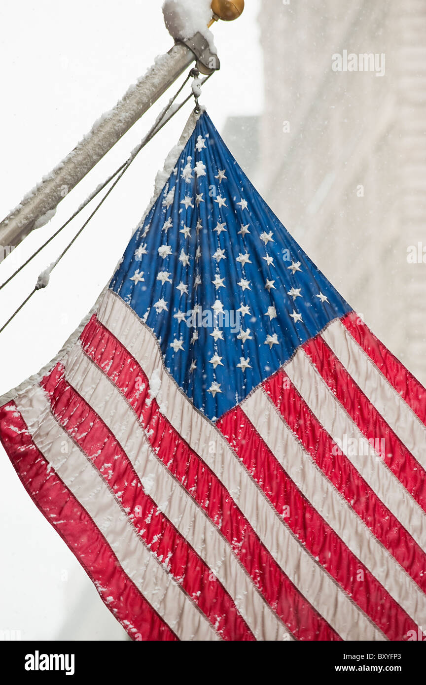 Snow covered American flag Stock Photo