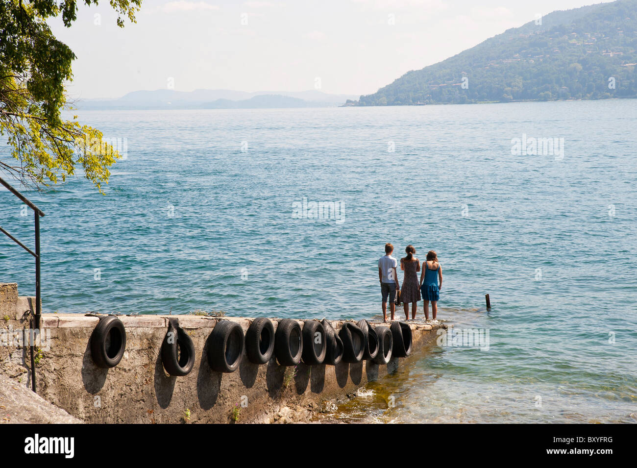 Three children on lake shore Stock Photo