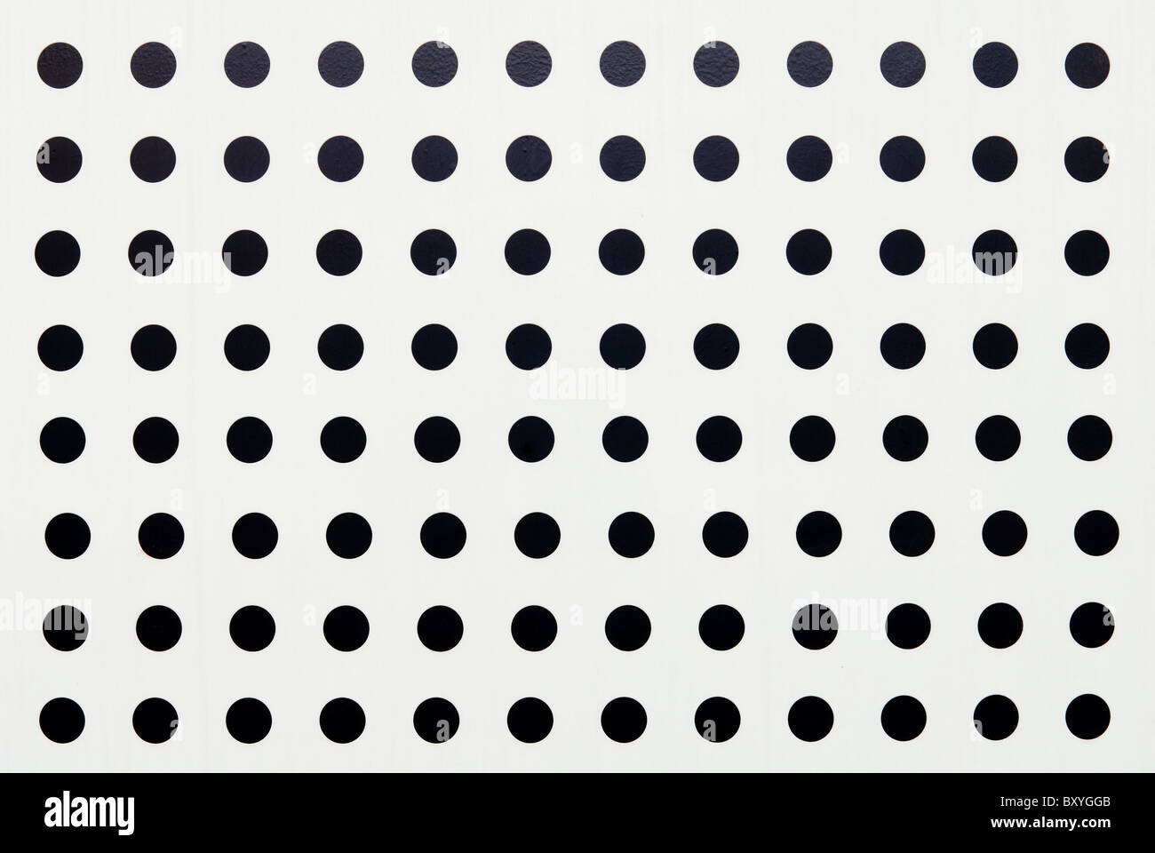 detail of a white metal panel with circular holes Stock Photo