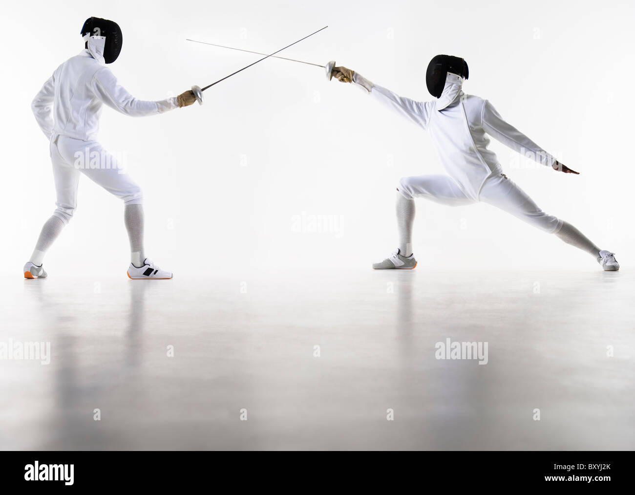 Studio shot of fencers in attacking lunge Stock Photo