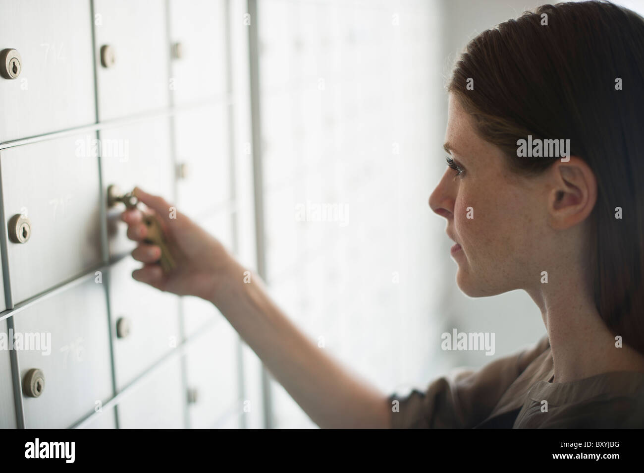 Woman opening mailbox Stock Photo Alamy
