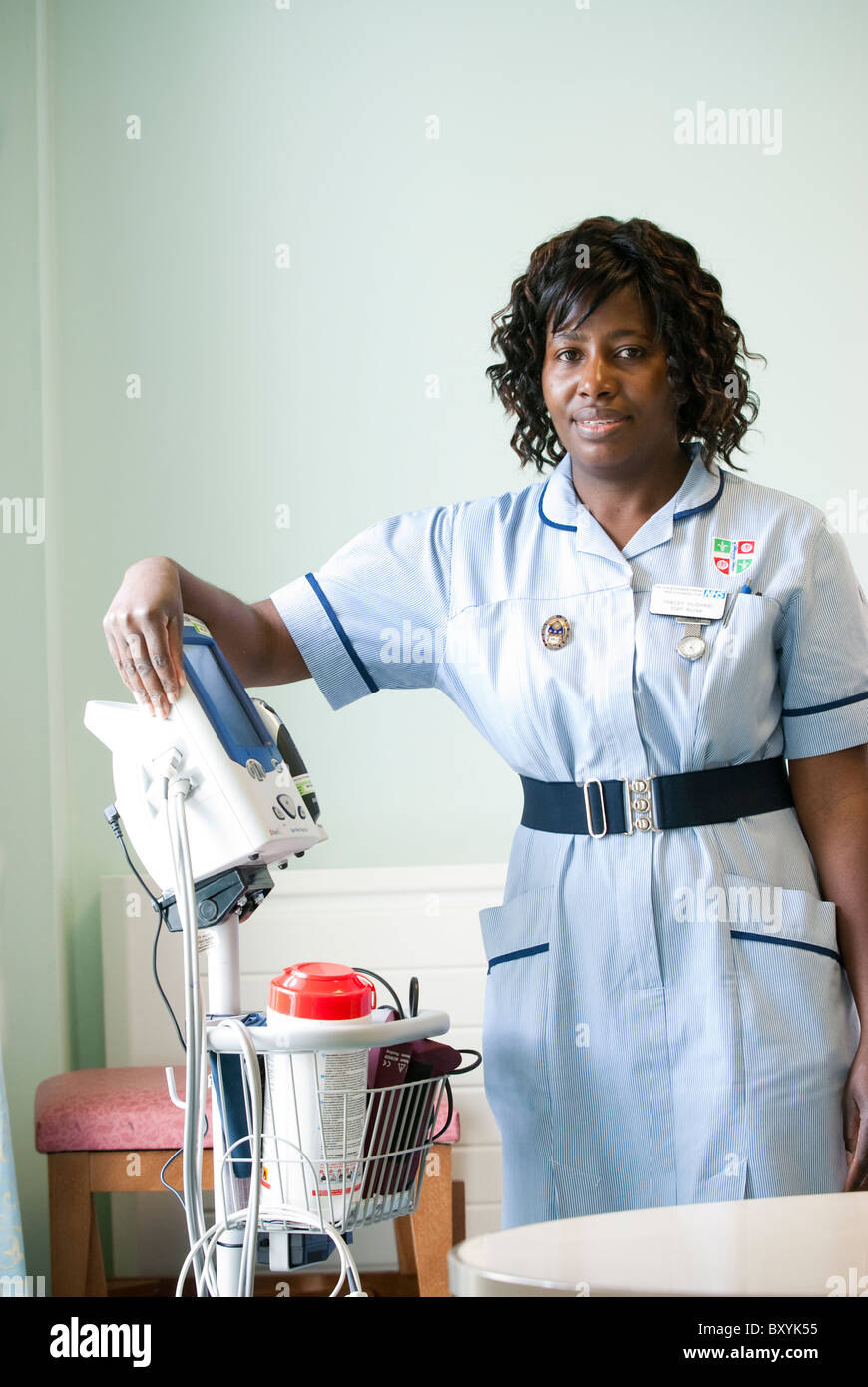 A young black nurse works on a hospital ward UK Stock Photo