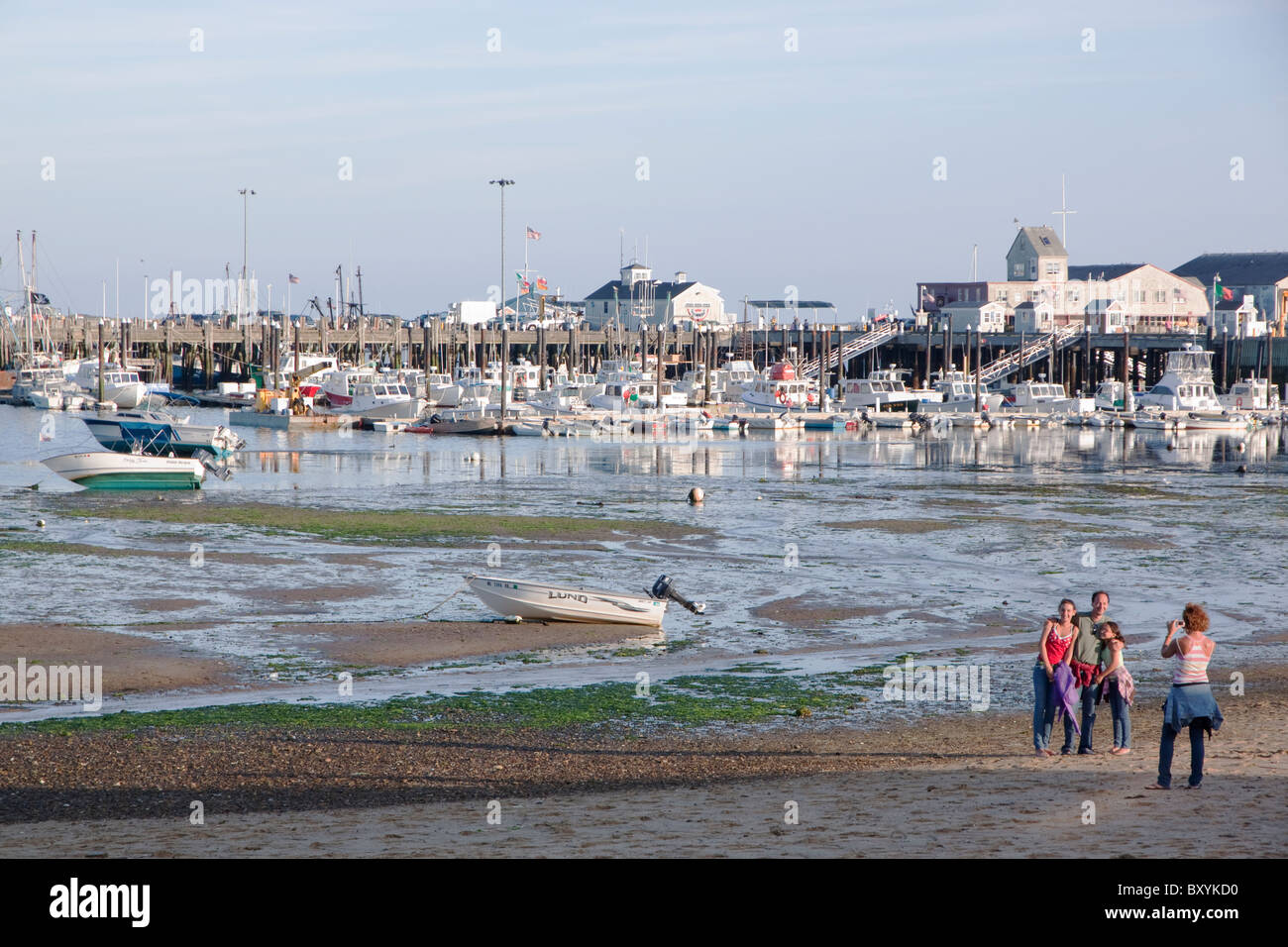A family portrait being taken in front of Provincetown Harbor while on vacation on Cape Cod. Stock Photo