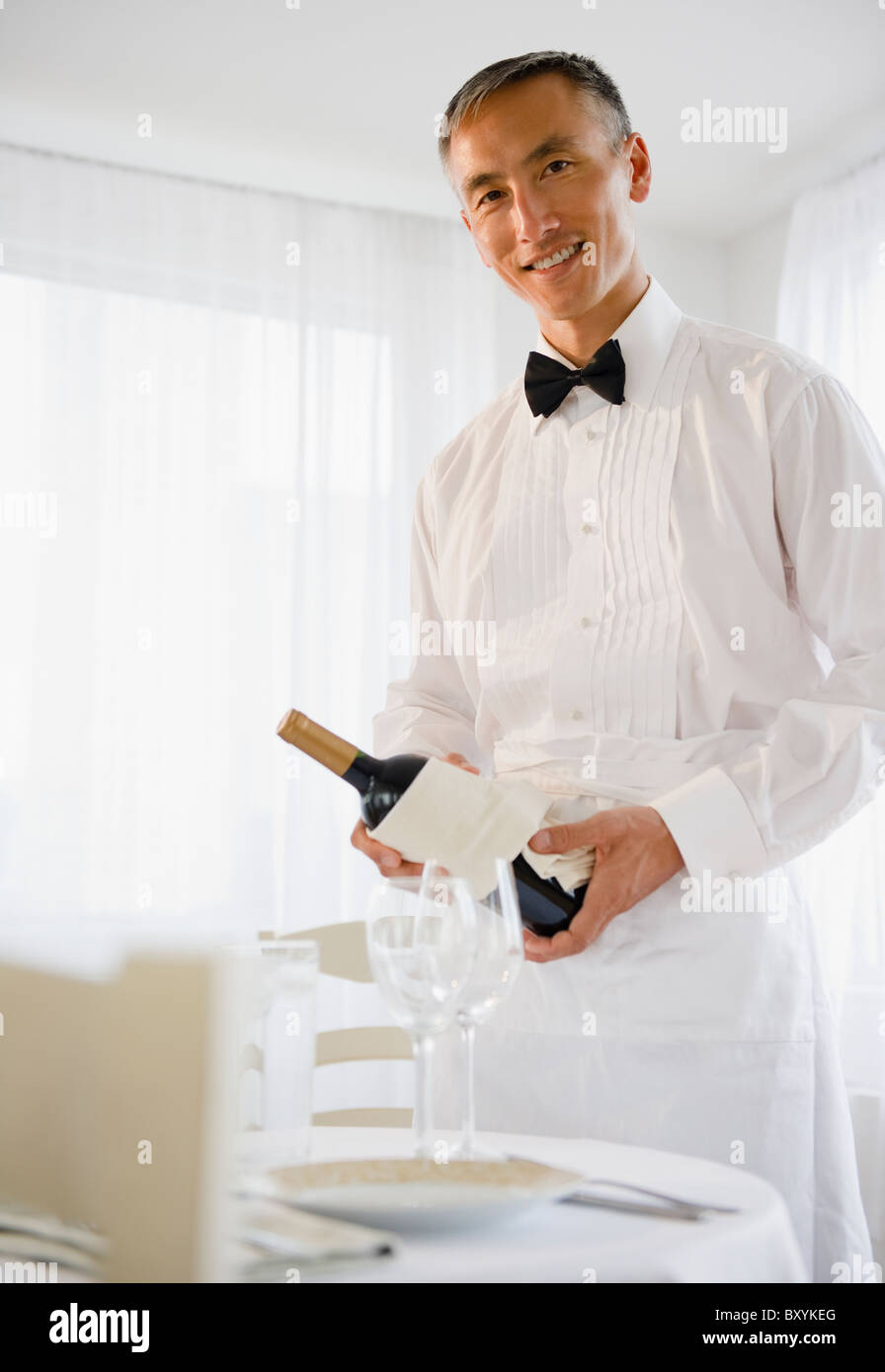 Waiter holding wine hi-res stock photography and images - Alamy