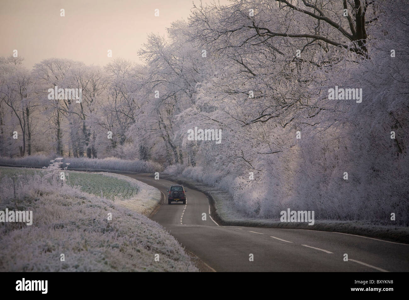 Hoar frost amd icy road on rural road in Suffolk UK Stock Photo