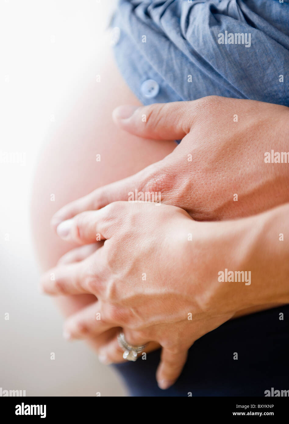 Young man hugging pregnant woman Stock Photo - Alamy