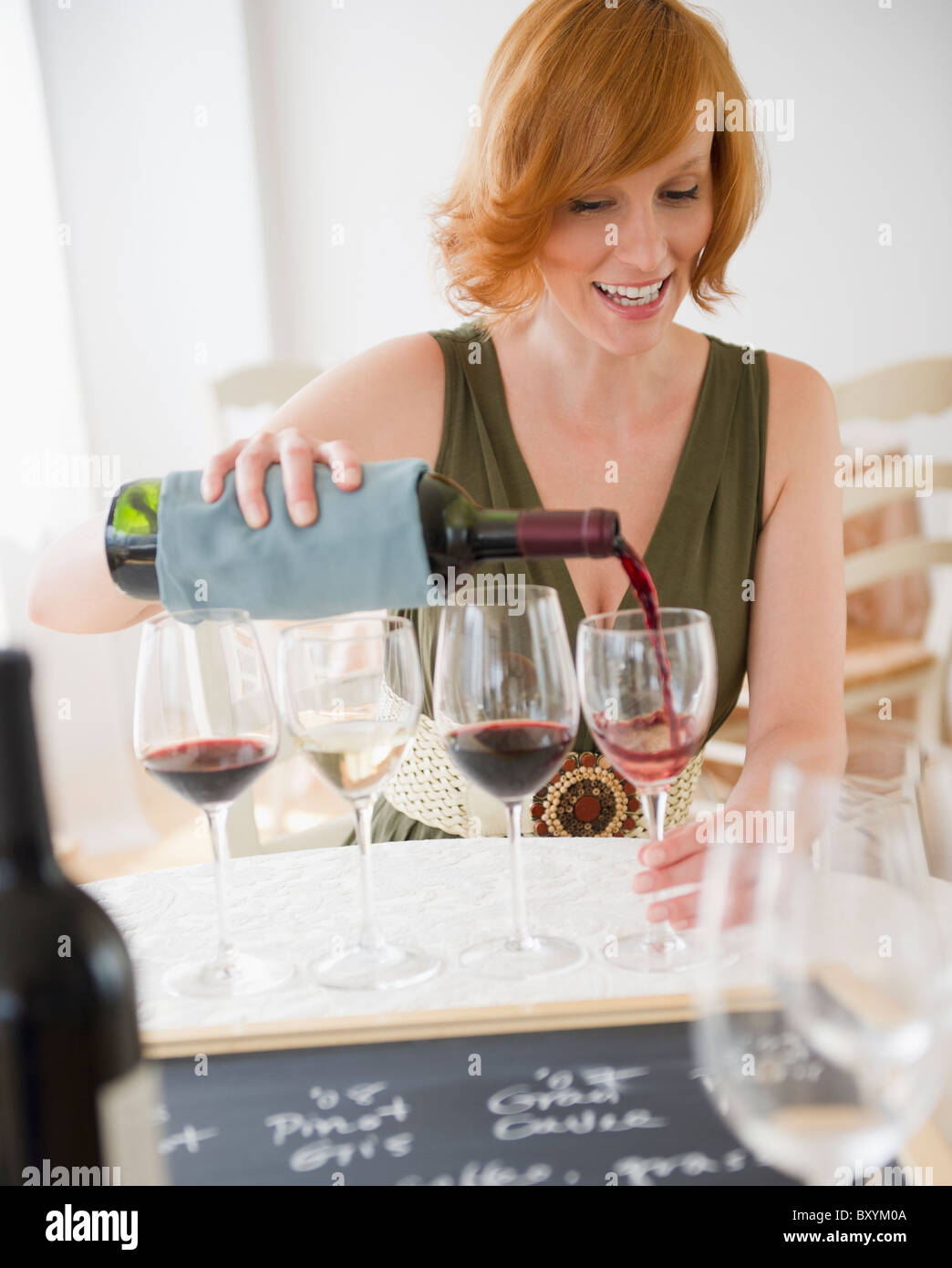Young woman pouring wine Stock Photo - Alamy