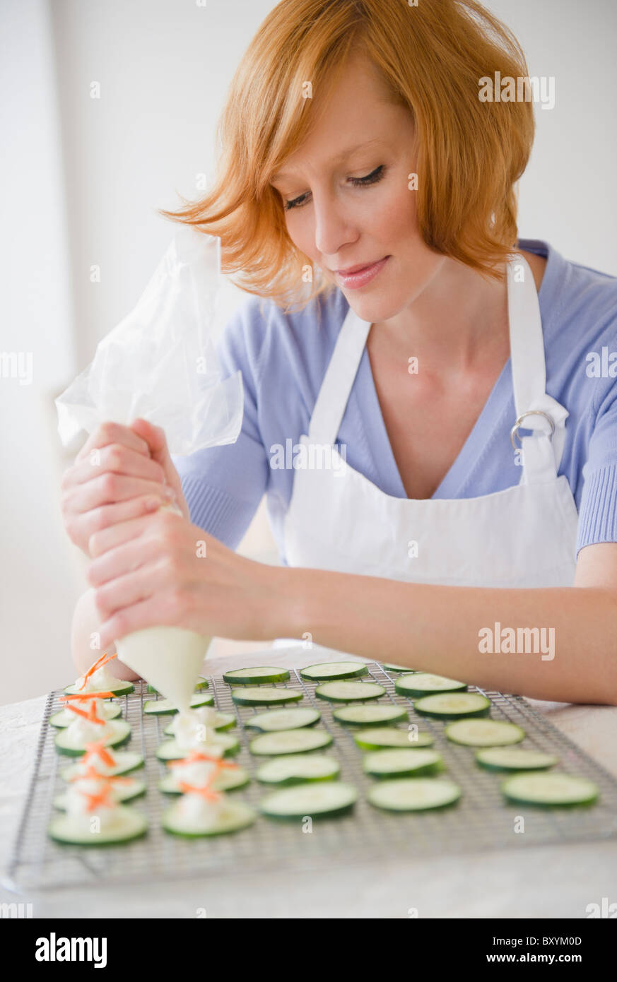 Young woman preparing appetizers Stock Photo