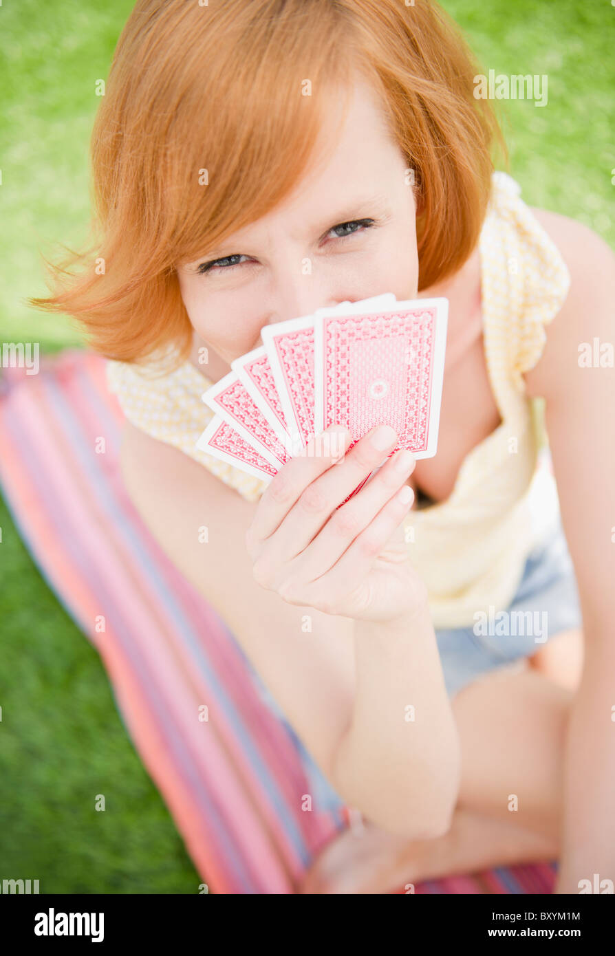 Young woman holding cards Stock Photo Alamy