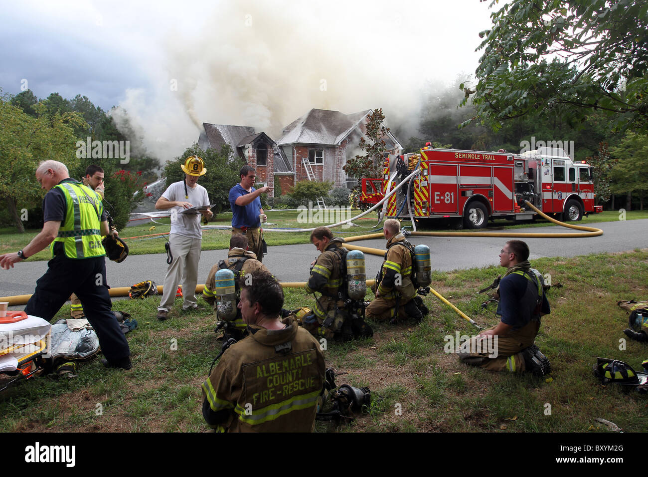 Firefighters take turns putting out a house fire in Charlottesville