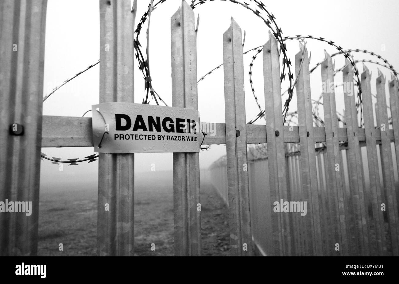 Danger sign warning of concertina razor wire mounted onto galvanized