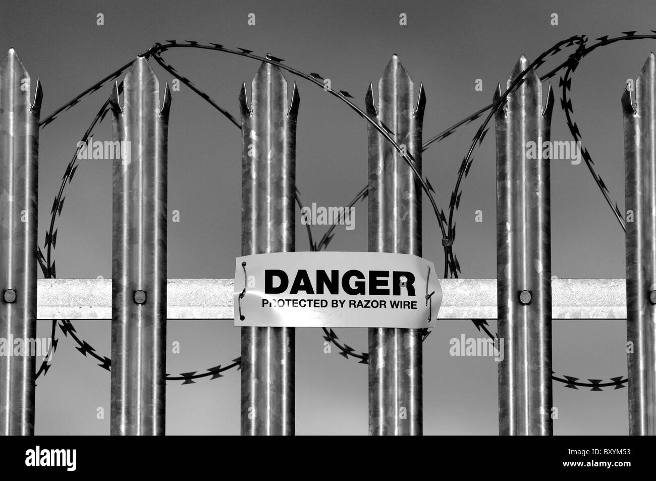Danger sign warning of concertina razor wire mounted onto galvanized