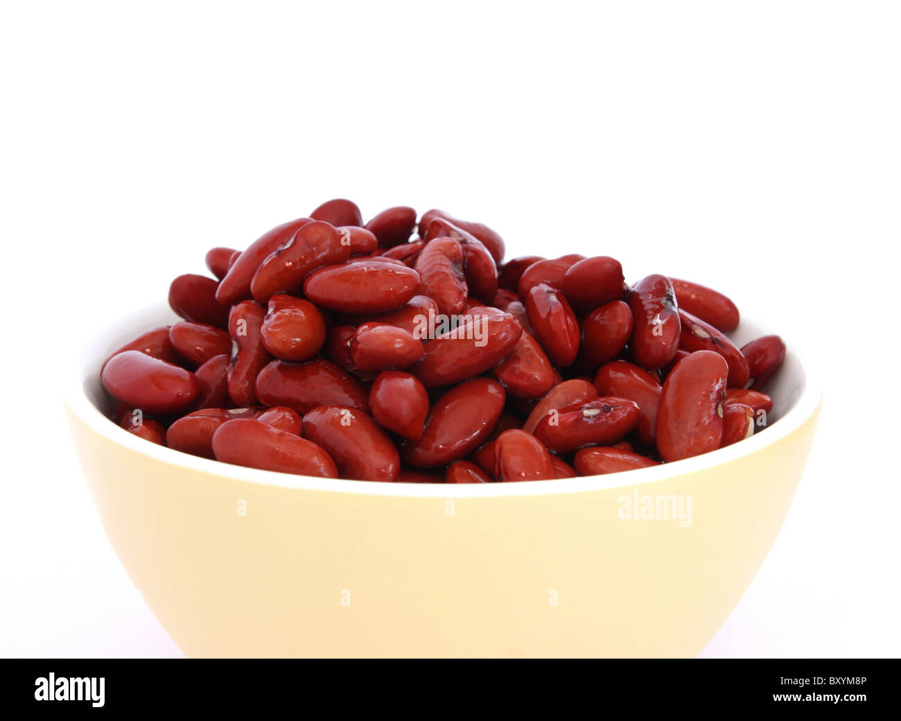 Many cooked red beans in yellow bowl on white background Stock Photo