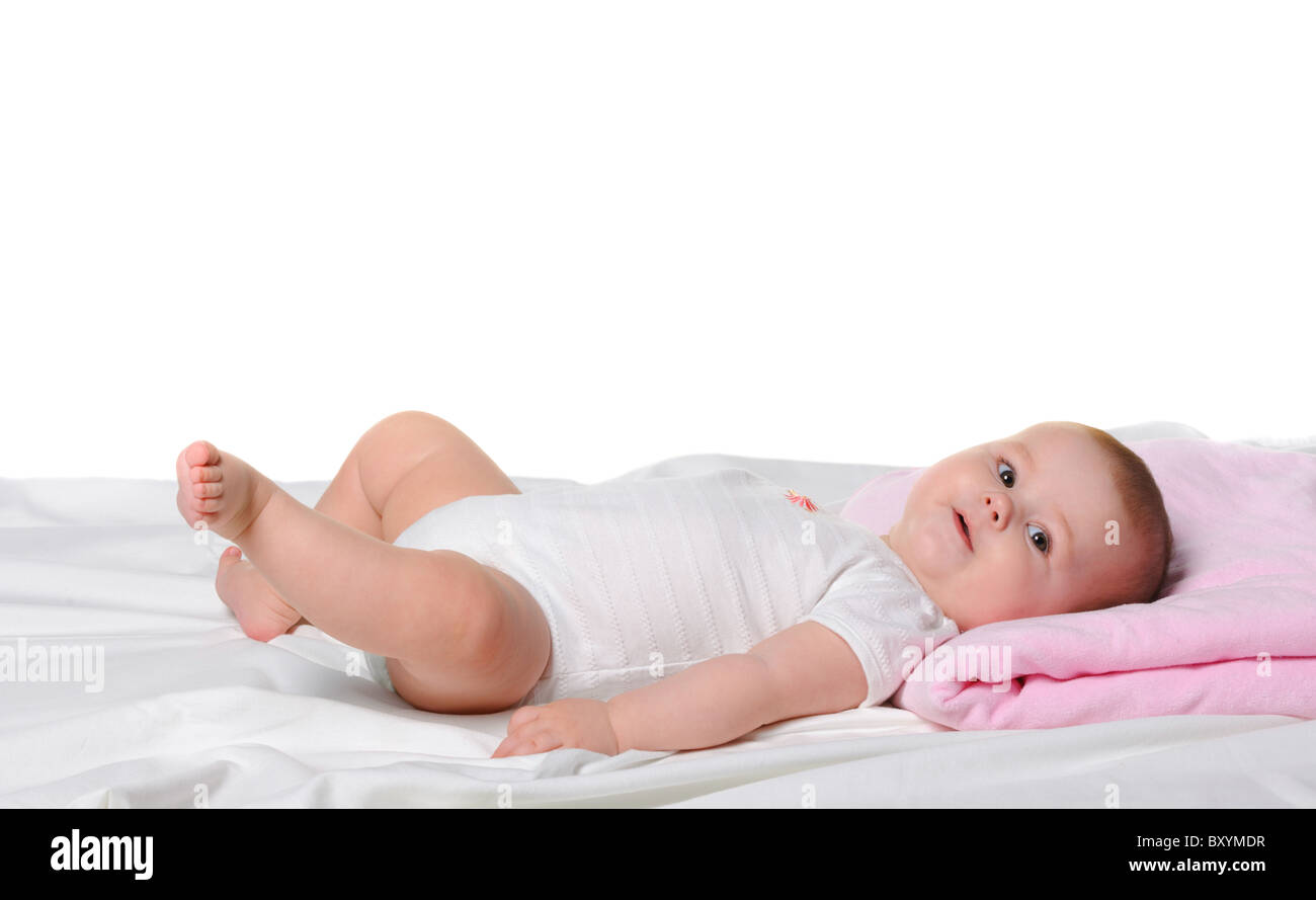 The baby lays. Age of 8 months. It is isolated on a white background