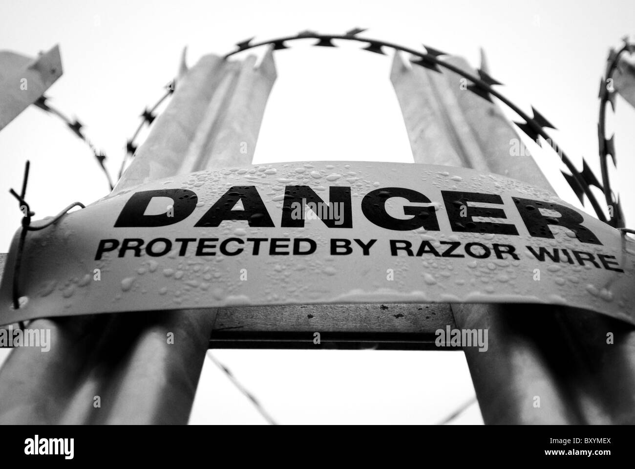 Danger sign warning of concertina razor wire mounted onto galvanized