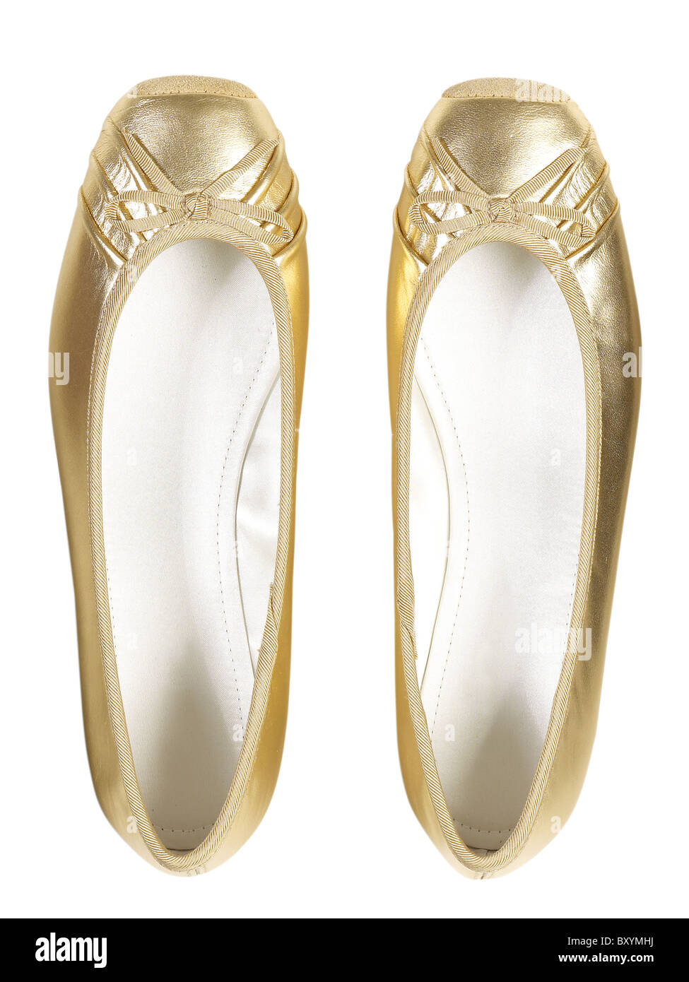 pair of girls gold flat shoes Stock 