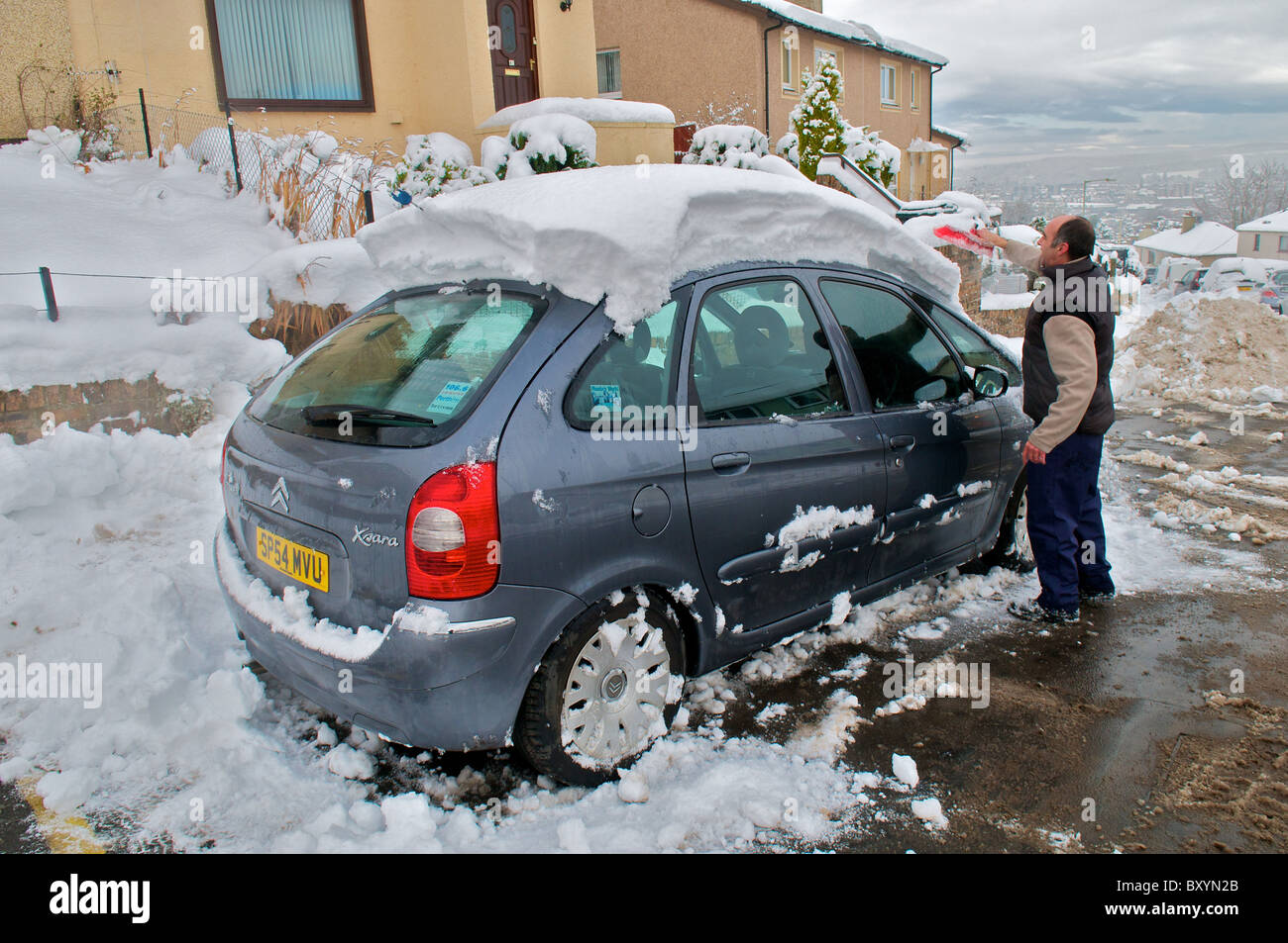 People trying to clear away the snow in the Scottish city of perth. Stock Photo