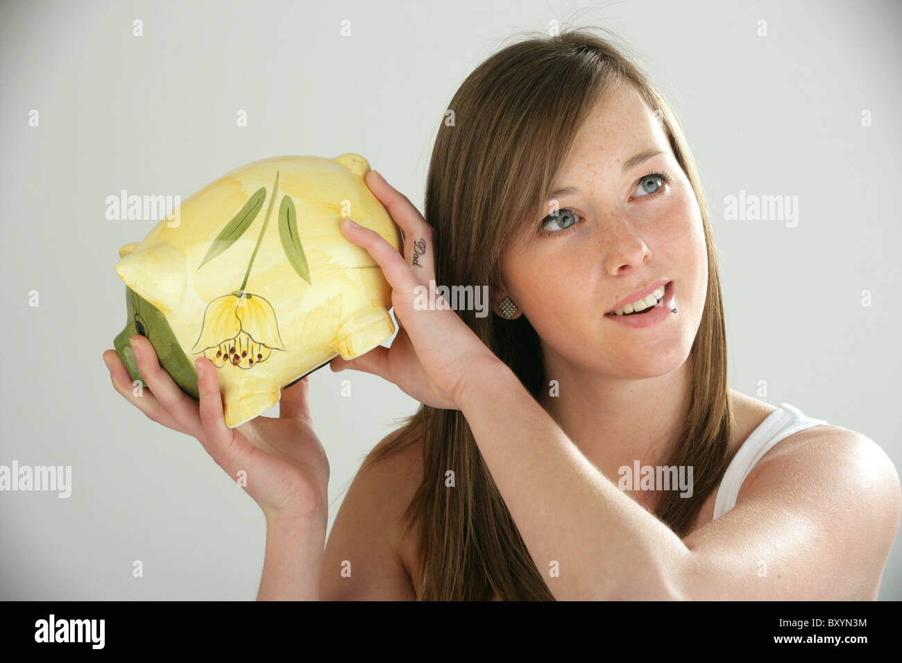 Pretty woman holding a piggy bank Stock Photo - Alamy