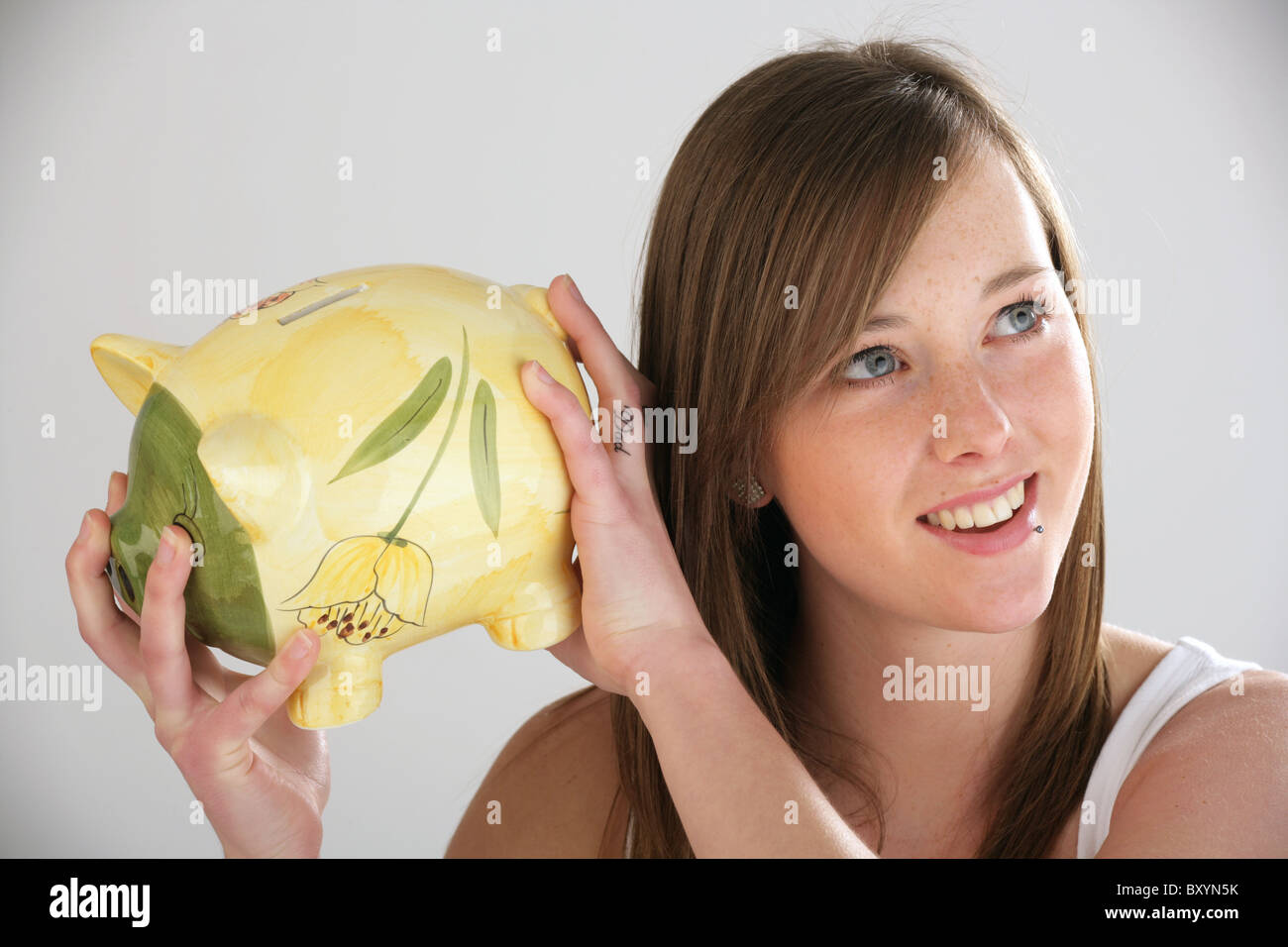 Pretty woman holding a piggy bank Stock Photo - Alamy