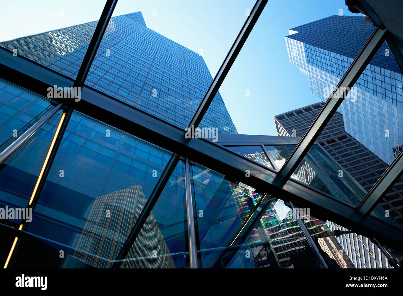 Tall skyscrapers seen through glass ceiling of modern office building Stock Photo