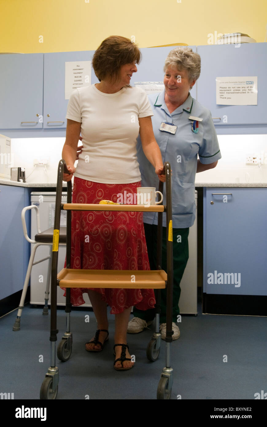 A woman is helped to walk in an occupational therapy unit by a nurse UK Stock Photo - Alamy