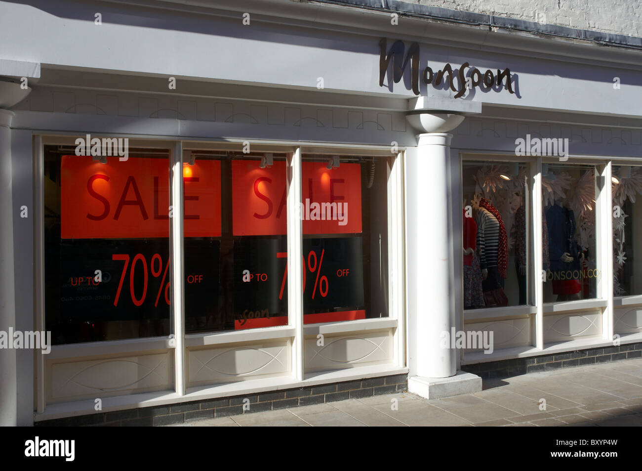 Monsoon shop fronts in Winchester, Hampshire, England showing the Monsoon logo and sale posters, January 2011. Stock Photo