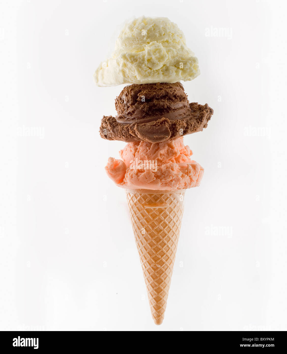 three flavored ice cream scoops on a cone isolated on white Stock Photo