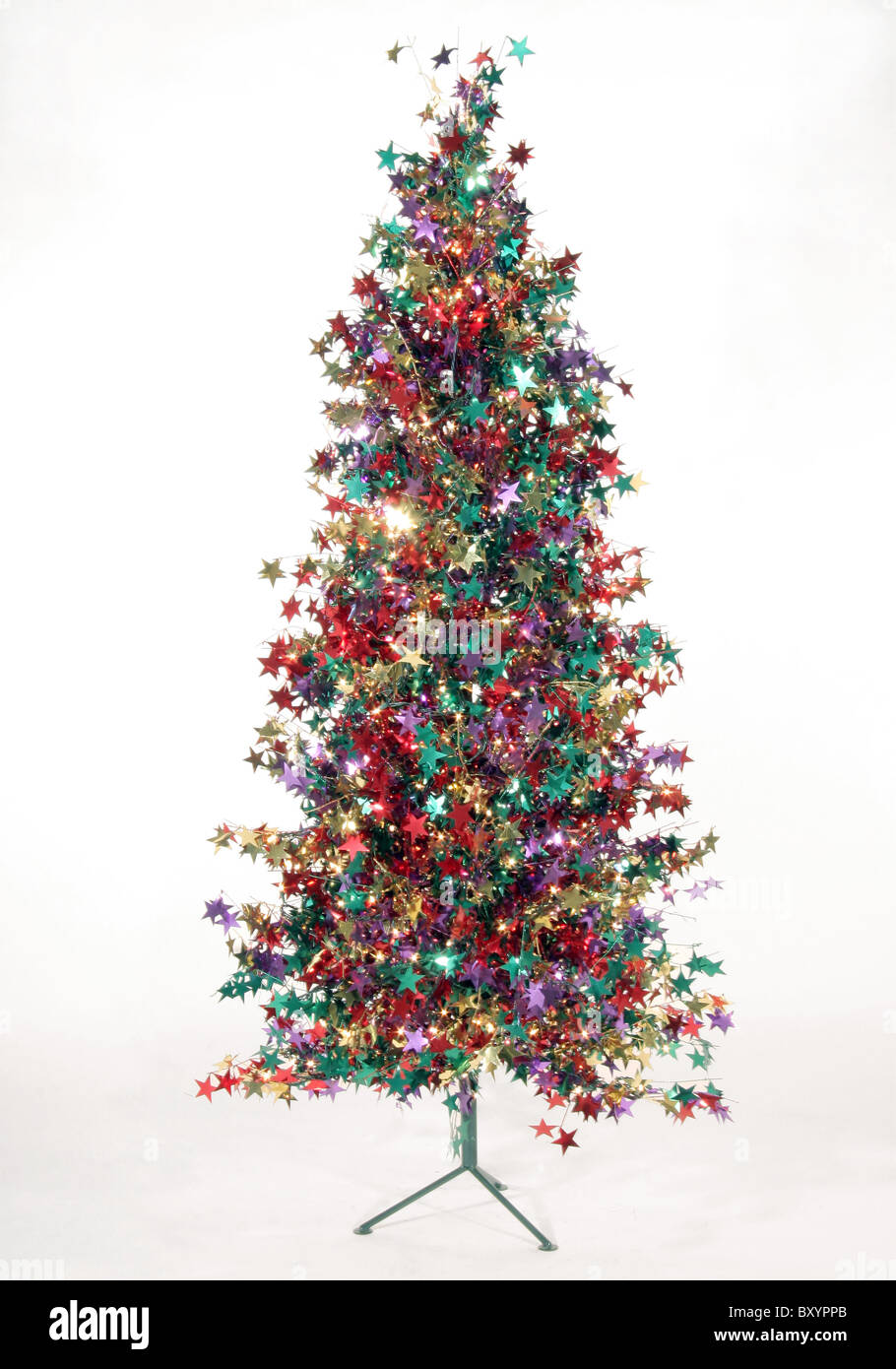 A Christmas tree made of multicolored foil stars sits on a white ...