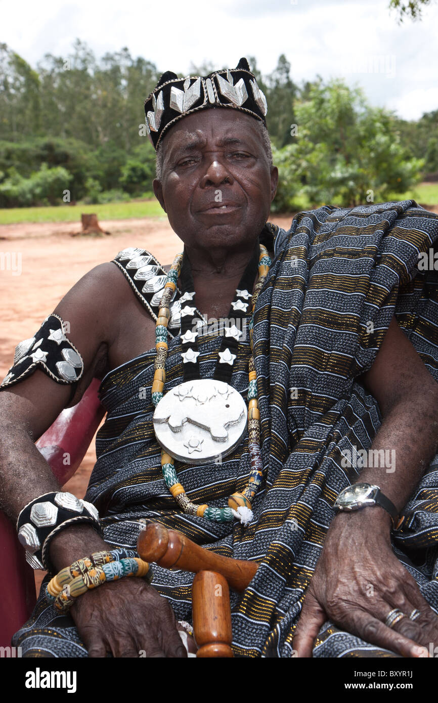 A local chief of the Esse minority people group bedecked with crown and other atrapments befitting royalty in rural West Africa. Stock Photo