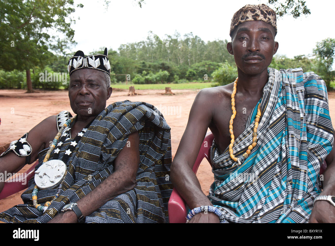 A local chief of the Esse minority people group bedecked with crown and other entrapments befitting royalty in rural West Africa. Stock Photo