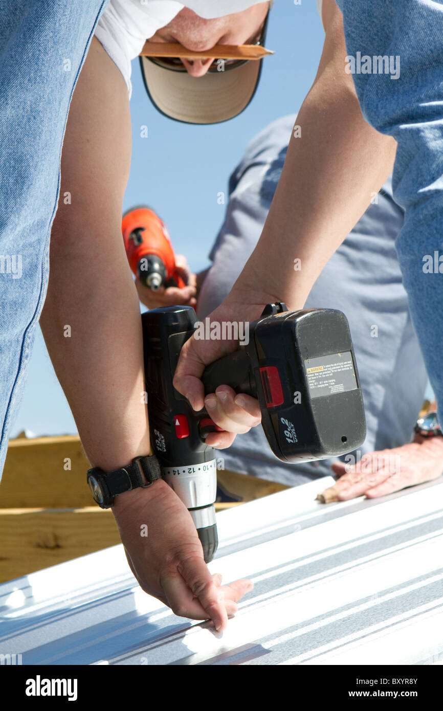 Carpenter construction worker use a battery powered drill to fasten