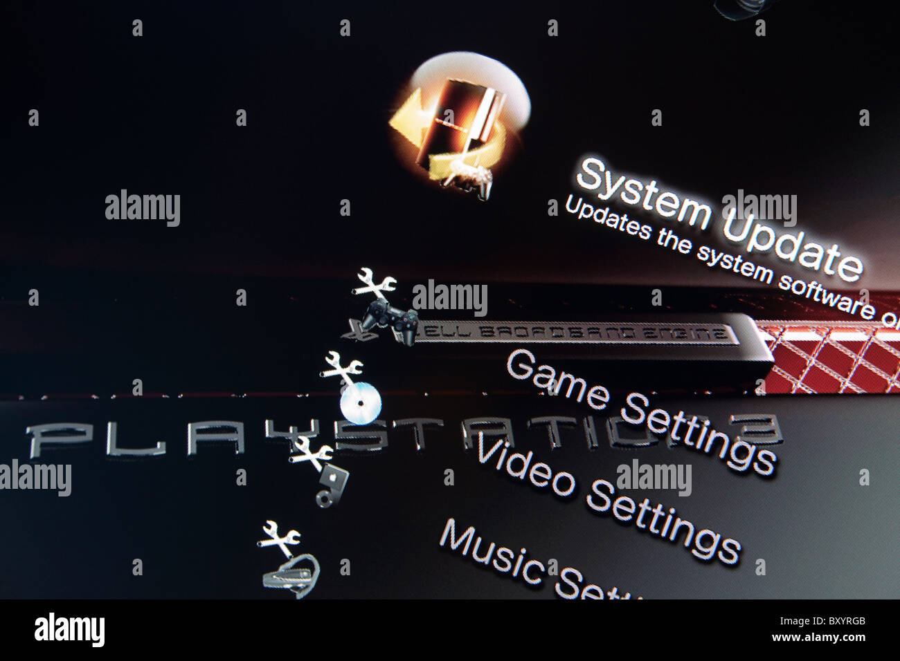 A Sony Playstation 3 PS3 menu highlighting the system update option recent news stories of users hacking in to the PS3 software Stock Photo