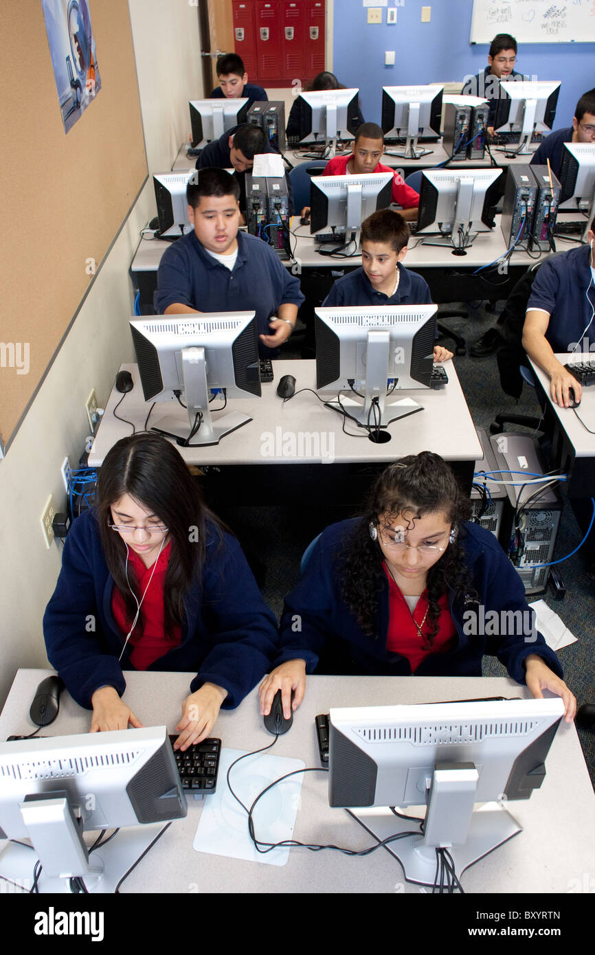 Male and female Hispanic students work on assignment in computer lab at ...