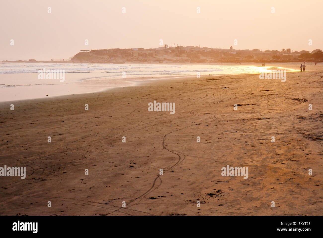 A beautiful stretch of beach on Ghana's central coast during low tide and at sunset. Stock Photo