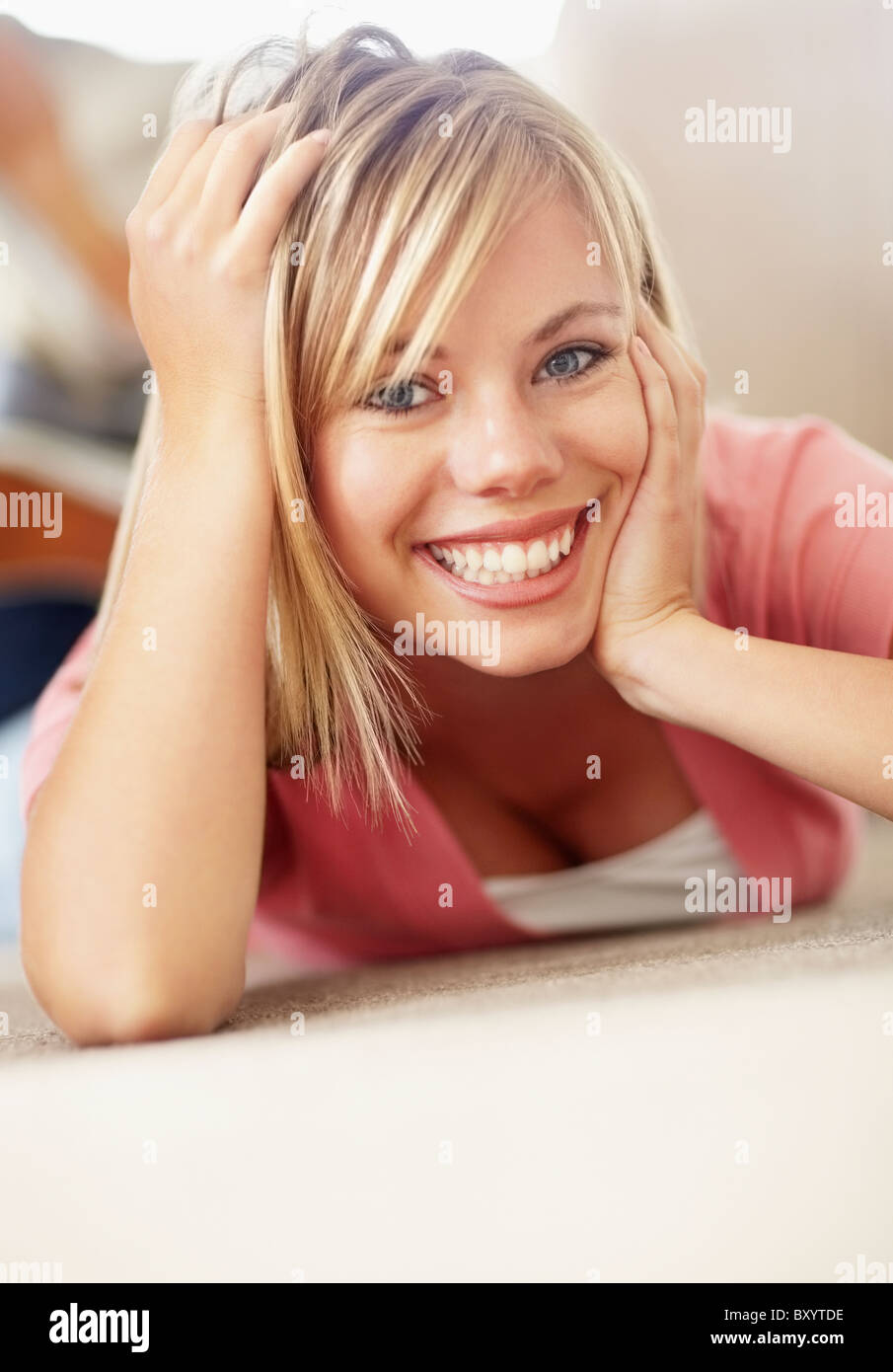 Cheerful blonde woman lying in hi-res stock photography and images - Alamy