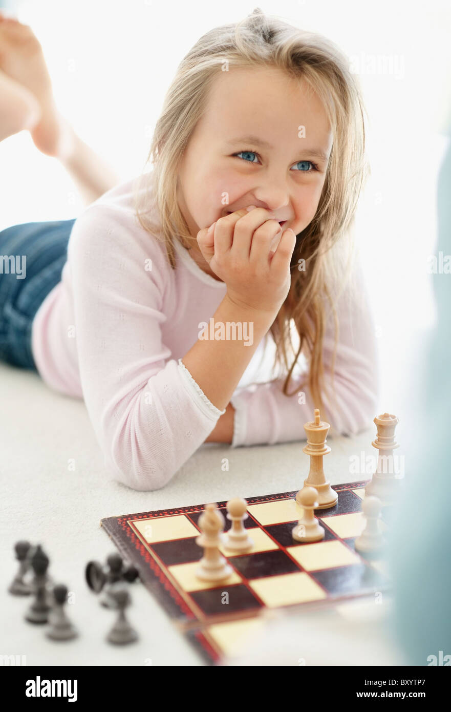 Girl playing chess Stock Photo
