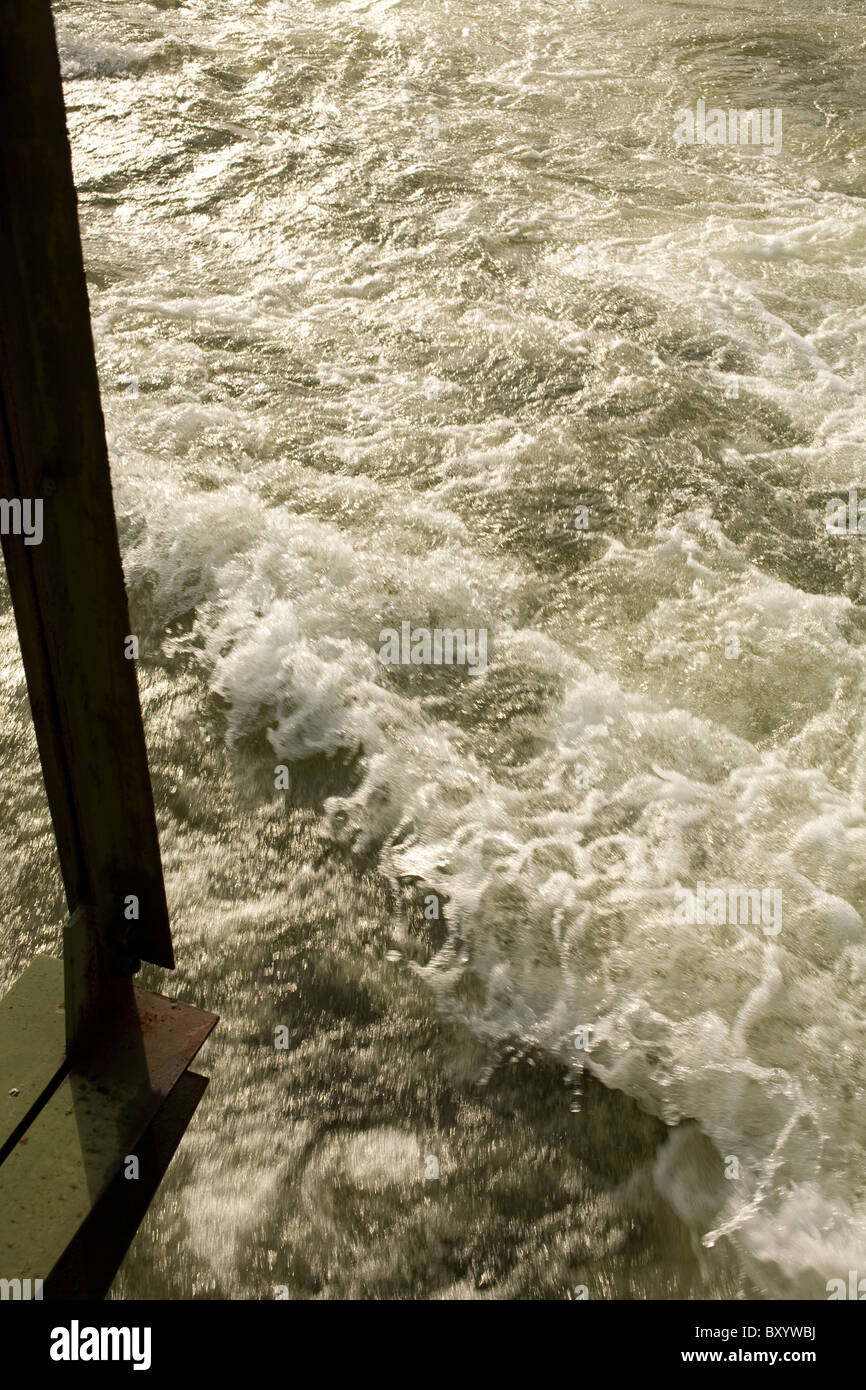 Flooding water rushes beneath a bridge in Turners Falls, MA Stock Photo